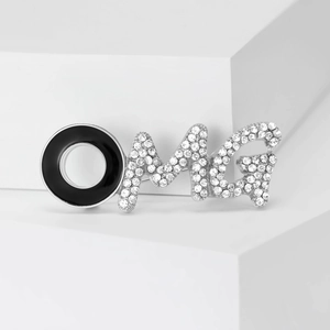 Detail of OMG letter brooch with black enamel and sparkling white rhinestones