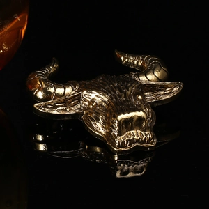 Detail of vintage gold bull head brooch showing intricate textures and muscle lines