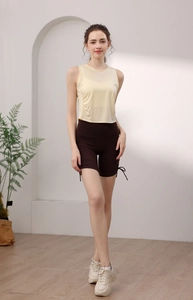 Detail view of high-waist sports shorts with adjustable side drawstrings and ties