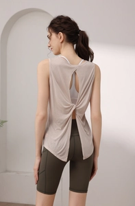Detail view of back hollow-out knot yoga tank top with green high-waist biker shorts
