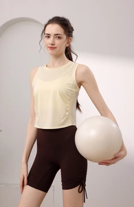 Detail of light yellow mesh sports vest and dark brown drawstring yoga shorts