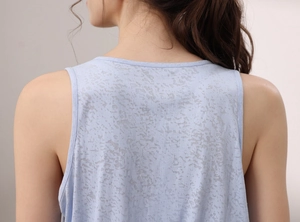 Close-up of light blue yoga tank top featuring breathable burnout jacquard texture detail