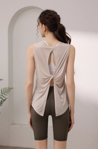 Detail of loose yoga tank top featuring a back twist design and breathable fabric