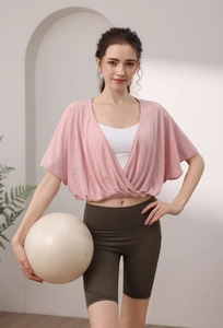 Detail of pink jacquard batwing sleeve yoga top with breathable mesh and cross-cut design
