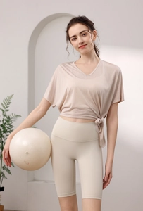 Détail du haut de sport beige avec lien à la taille et short de cyclisme de yoga assorti