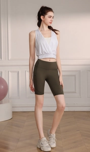 Macro detail of breathable white jacquard tank top and olive green cycling shorts outfit
