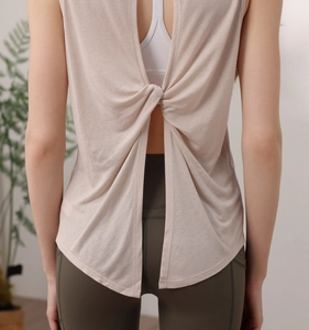 Detail view of back twist knot and breathable slit on pink sleeveless yoga top
