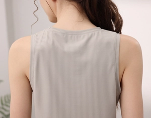 Détail de la maille côtelée beige clair et des coutures au dos du haut de yoga sans manches