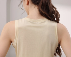Detail of light beige tencel athletic tank top showing collar stitching and soft fabric