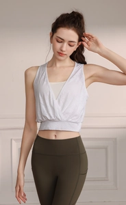 Close-up of jacquard nylon fabric on white V-neck sports vest and olive green yoga pants