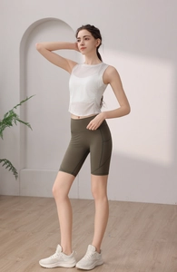 Minimalist white tencel yoga tank top with olive green high-waist cycling shorts