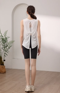 Detail view showing back crossover twist and cutout design of a white sports tank top