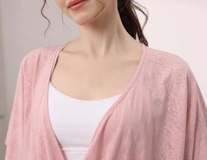 Detail of light pink jacquard yoga top showing breathable textured fabric and drape