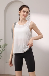 Detail of loose tencel breathable white yoga vest paired with black cycling shorts