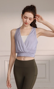 Detail view of light purple yoga vest and olive green high waist leggings on model