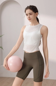 Detail of white double-layer athletic tank top and olive high-waisted yoga shorts set