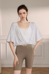 Detail of white jacquard mesh yoga cover-up with breathable batwing sleeve and V-neckline