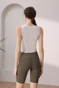 Detailed back view of white sleeveless crop top and olive green yoga shorts with ergonomic seams