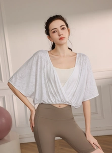 Detail of loose-fit batwing sleeve yoga cover-up showing breathable jacquard nylon fabric