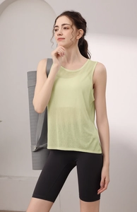 Detail of light green yoga tank top showing breathable micro-perforated tencel fabric