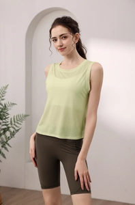 Close-up of lime green mesh yoga tank top and dark olive cycling shorts for women