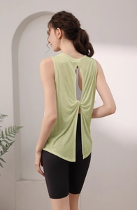 Detail of light green yoga tank top showing stylish open back and twist knot design