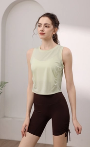 Detail of lime green yoga vest featuring side ruching and breathable fabric for fitness