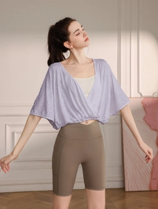 Detail of lavender wrap sports top with breathable jacquard fabric and mobile side pockets