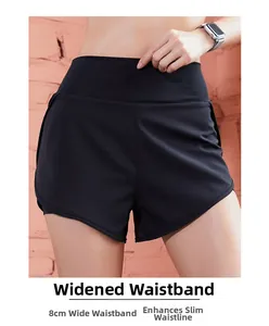 Close-up of black sports shorts featuring an 8cm wide high-waist band for tummy control