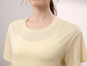 Detailansicht des atmungsaktiven gelben Netzstoffs am Halsausschnitt des Sportshirts