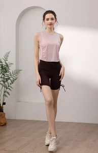 Detail of pink tencel sports tank top and brown drawstring shorts on a model