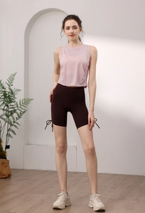 Detail of light pink Tencel tank top with side pleats and drawstring cycling shorts