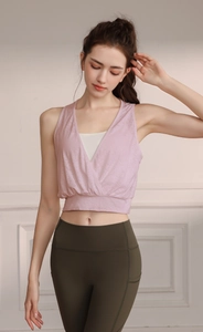 Detail of light pink jacquard yoga vest showing deep V-neck and white built-in bra liner