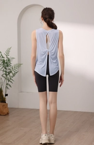 Detail of the open back knot design on a light blue tencel yoga tank top for women