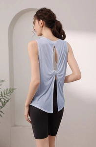 Detail view of light blue sports tank top with twist open back design and breathable fabric