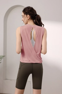Detail view of the open-back breathable yoga top and high-waist green fitness shorts