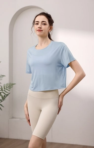 Detail eines hellblauen Kurzarm-Sport-T-Shirts kombiniert mit beige Fitness-Shorts