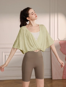 Close-up of light green breathable jacquard yoga cover-up with stylish batwing sleeves