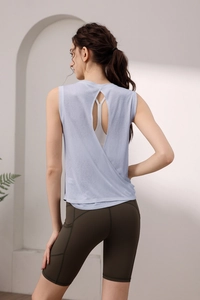 Macro detail of breathable back cutout design and side pockets on yoga tank top