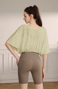 Detail view of jacquard batwing sleeve yoga top with breathable mesh texture and back profile