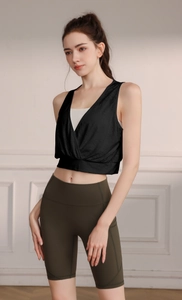 Detail of cross-back design on women's black jacquard sports vest with white layer