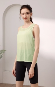 Detail of light green sleeveless yoga tank top paired with black cycling shorts