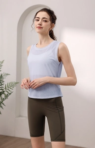 Close-up of breathable light blue sleeveless gym top with olive green yoga cycling shorts