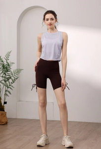 Detailed view of lilac tank top with high-waisted brown cycling shorts and drawstring hem