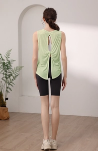 Detail of cross-knot back design on light green loose yoga vest with cutout detail