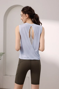 Detail of cross split backless yoga top in light blue with layered athletic design