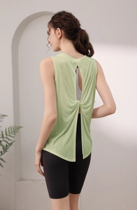 Detail view of light green tencel sports vest featuring a twisted hollow back design