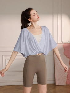 Detail of loose jacquard yoga top with breathable batwing sleeves and elastic hem