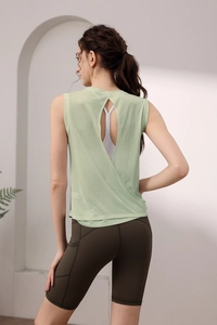 Detail view of the open-back breathable yoga tank top in light green for gym fitness