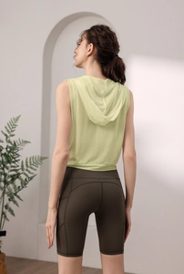 Détail du gilet de yoga à capuche respirant et du short de sport avec poche latérale